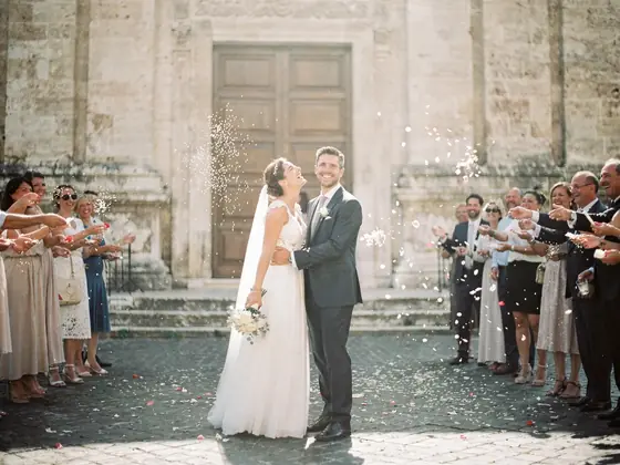 A photo book page: the couple leaving the church under a shower of rice